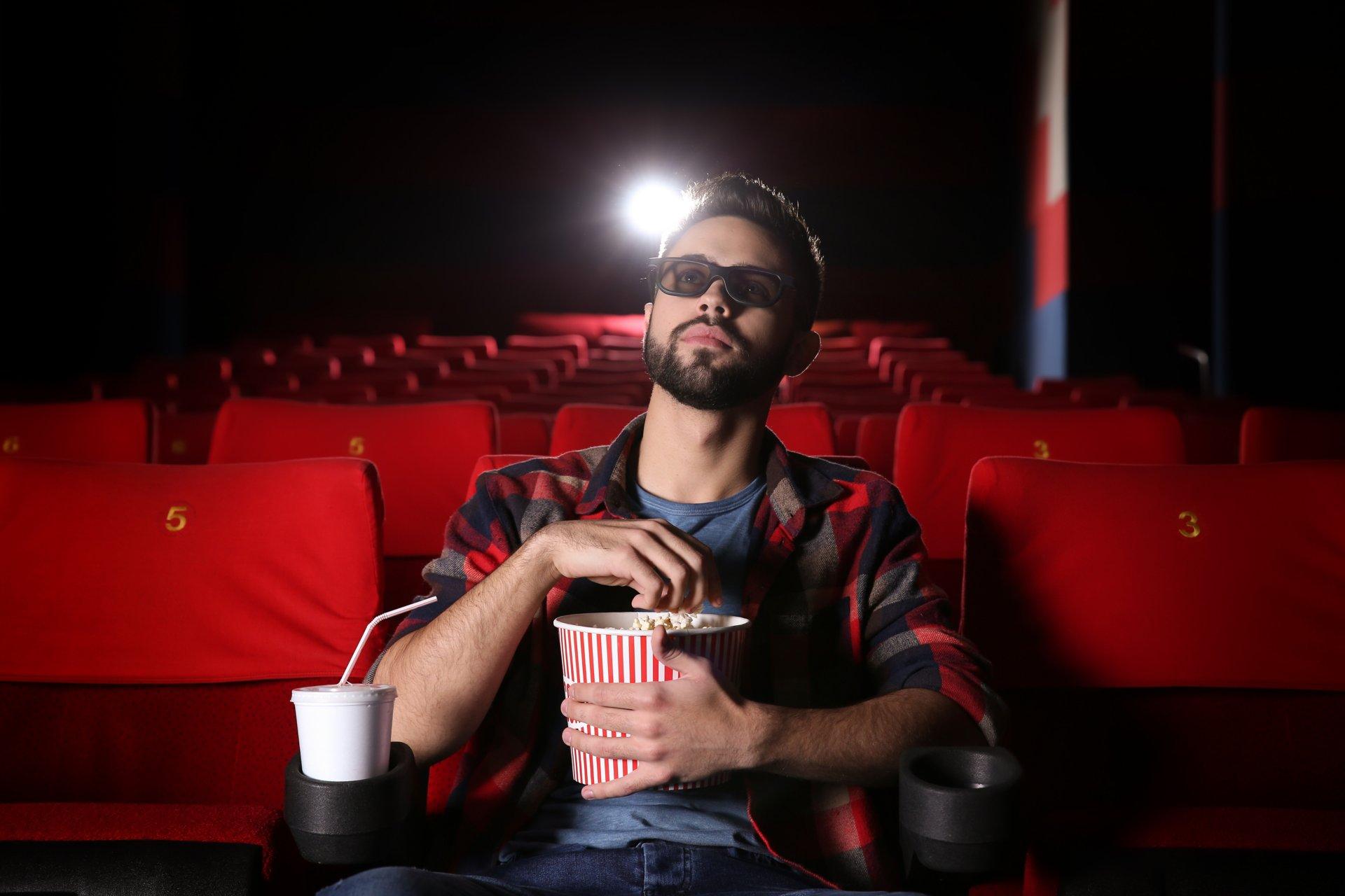 Young man watching movie in cinema