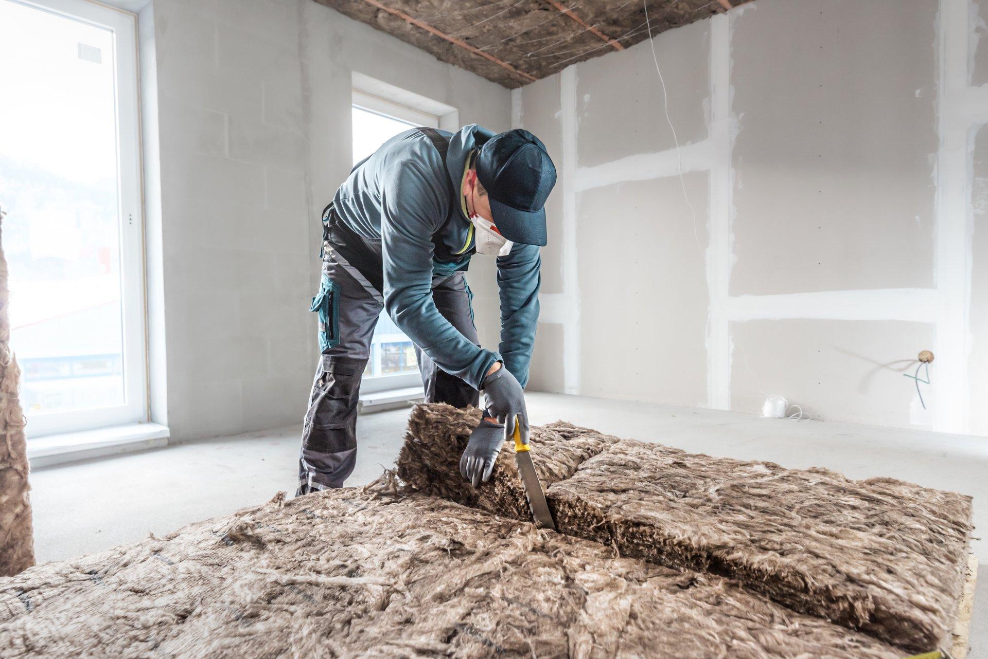 Cutting a thermal insulation from glass wool using a knife for stone wool